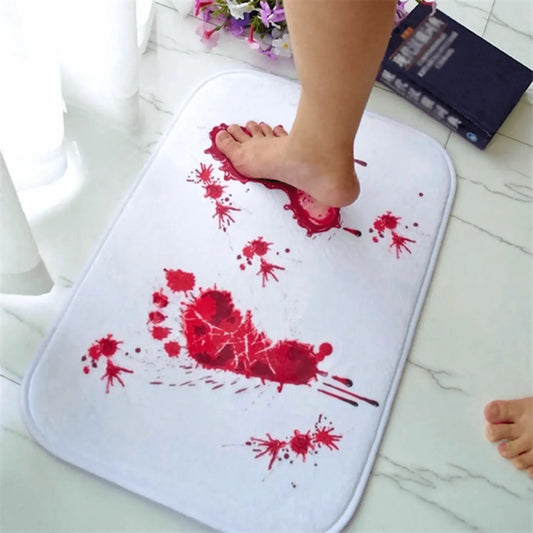 White novelty bath mat with red fake blood footprint design, foot stepping on it, modern bathroom setting