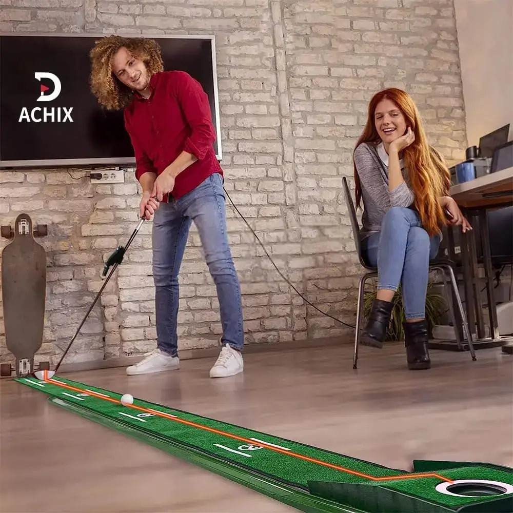 Man playing indoor putting green golf game while woman watches and smiles in modern living room