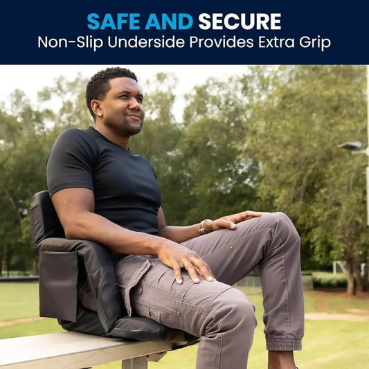 Man sitting outdoors on a bleacher seat with padded, non-slip cushion and back support.