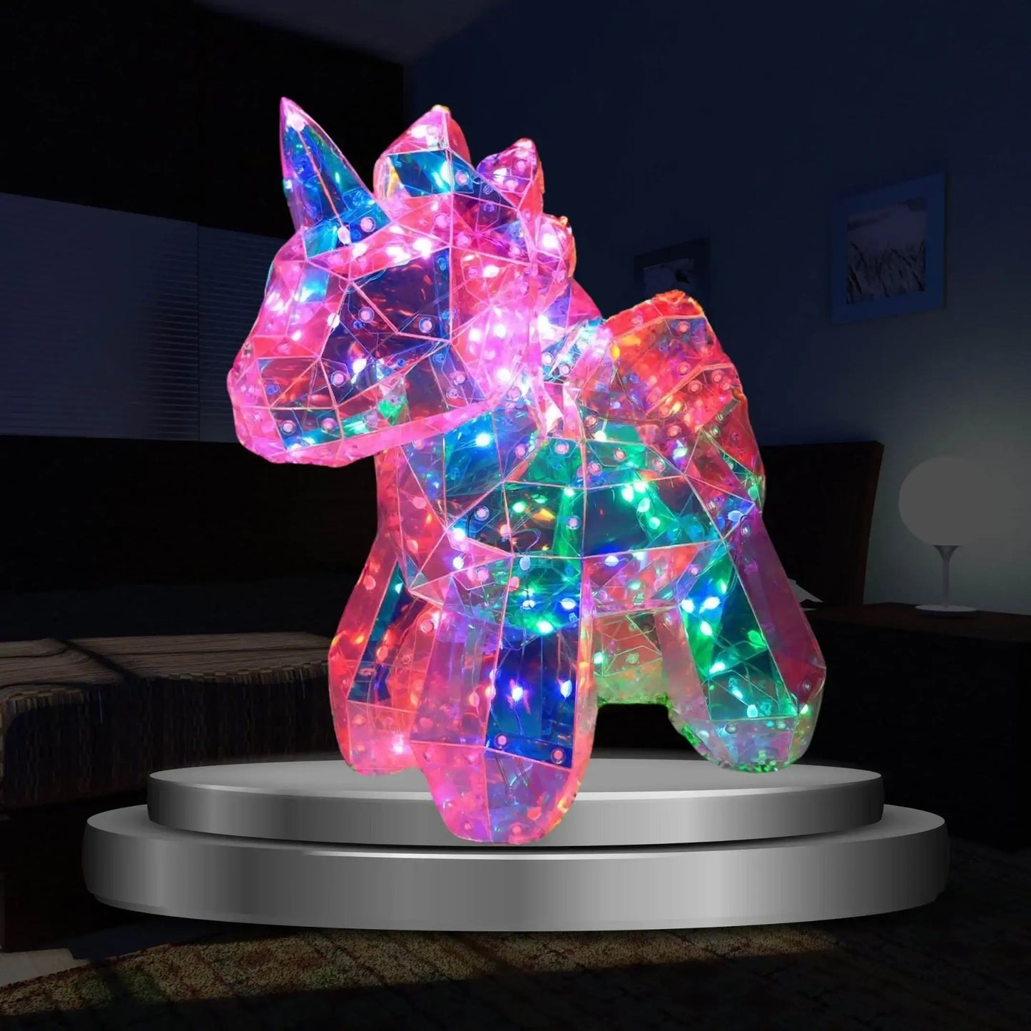 Colorful LED unicorn night light on a pedestal in a dark room