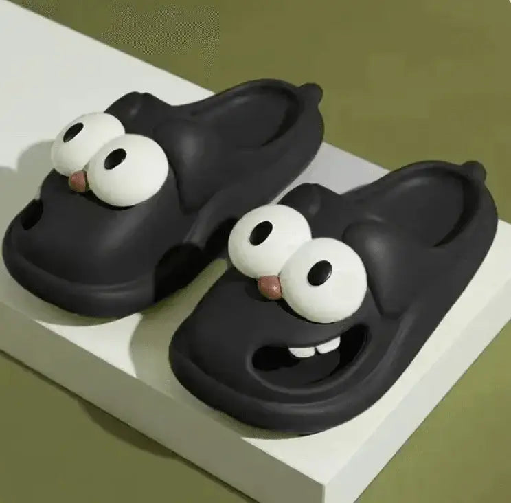 Black cartoon animal slippers with big eyes and a playful face, novelty indoor footwear