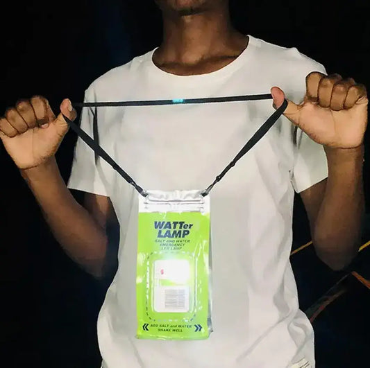 Person wearing a salt and water powered emergency LED lamp pouch around neck