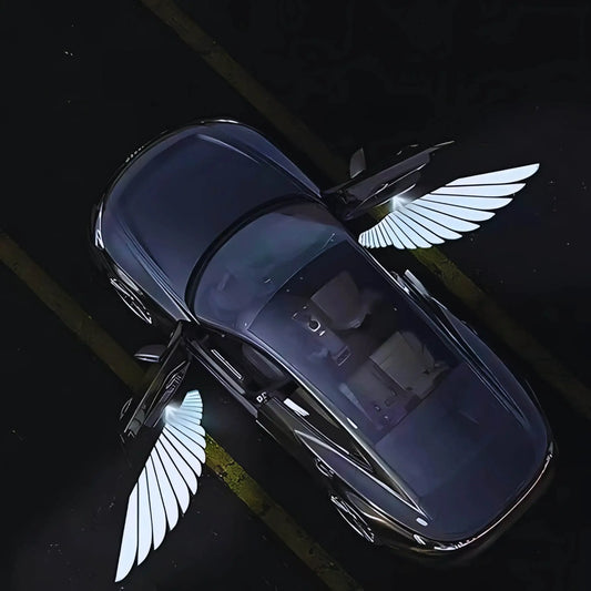 Overhead view of a parked car with open doors, featuring glowing wing-shaped lights on pavement.