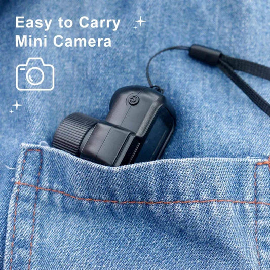 Compact mini camera with wrist strap shown in a denim pocket, easy to carry portable gadget.
