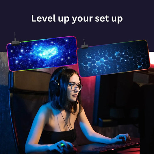 Female gamer at computer with RGB gaming mouse pads, galaxy and hexagon designs, setup inspiration