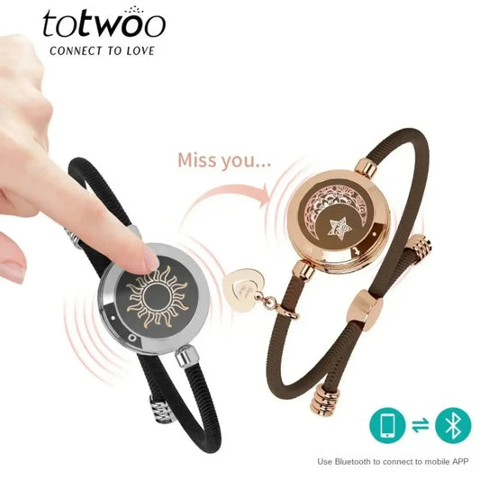 Two smart matching bracelets with sun and moon designs, connected by touch via Bluetooth app.
