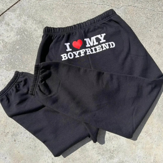 Black sweatpants with 'I love my boyfriend' text and heart graphic on waistband, casual loungewear