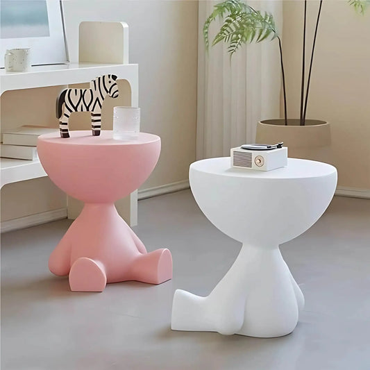 Modern minimalist side tables in pink and white with playful, abstract shapes in a cozy room